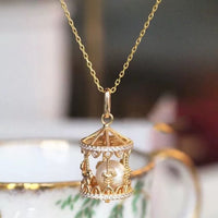 Luxe Carousel Pearl Pendant Necklace featuring a luminous pearl suspended inside an intricately detailed carousel pendant with sparkling accents and a gold-tone finish on a 40 + 5 cm chain.