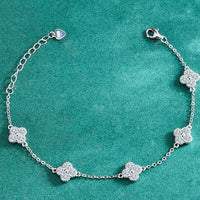 Eternal Clover Moissanite Bracelet crafted in sterling silver with five pavé-set four-leaf clover motifs adorned with brilliant moissanite stones and an adjustable chain.