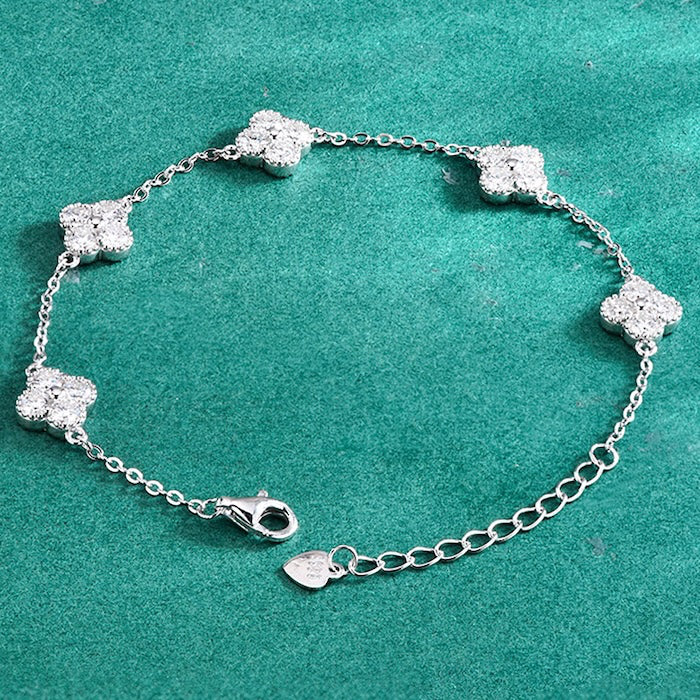 Eternal Clover Moissanite Bracelet crafted in sterling silver with five pavé-set four-leaf clover motifs adorned with brilliant moissanite stones and an adjustable chain.