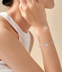 Eternal Clover Moissanite Bracelet crafted in sterling silver with five pavé-set four-leaf clover motifs adorned with brilliant moissanite stones and an adjustable chain.