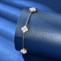Eternal Clover Moissanite Bracelet crafted in sterling silver with five pavé-set four-leaf clover motifs adorned with brilliant moissanite stones and an adjustable chain.