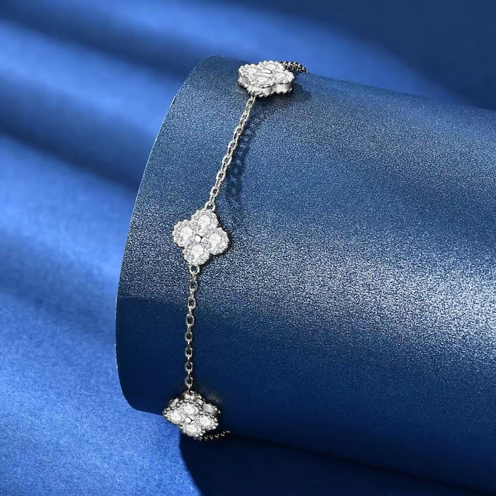 Eternal Clover Moissanite Bracelet crafted in sterling silver with five pavé-set four-leaf clover motifs adorned with brilliant moissanite stones and an adjustable chain.