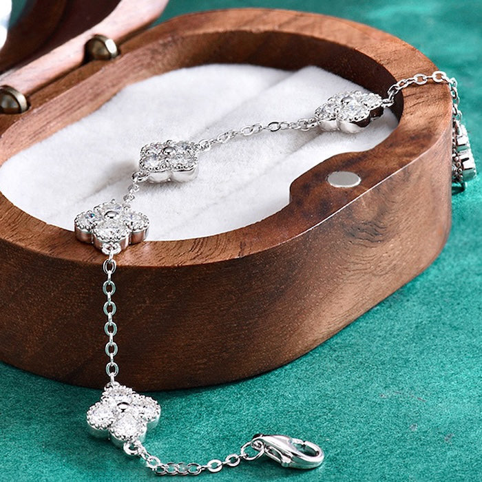 Eternal Clover Moissanite Bracelet crafted in sterling silver with five pavé-set four-leaf clover motifs adorned with brilliant moissanite stones and an adjustable chain.