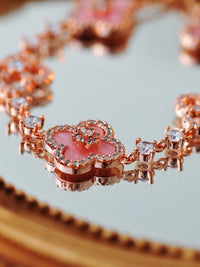 Blooming Clover Charm Bracelet featuring clover blossom charms accented with sparkling stones and an adjustable slider clasp.