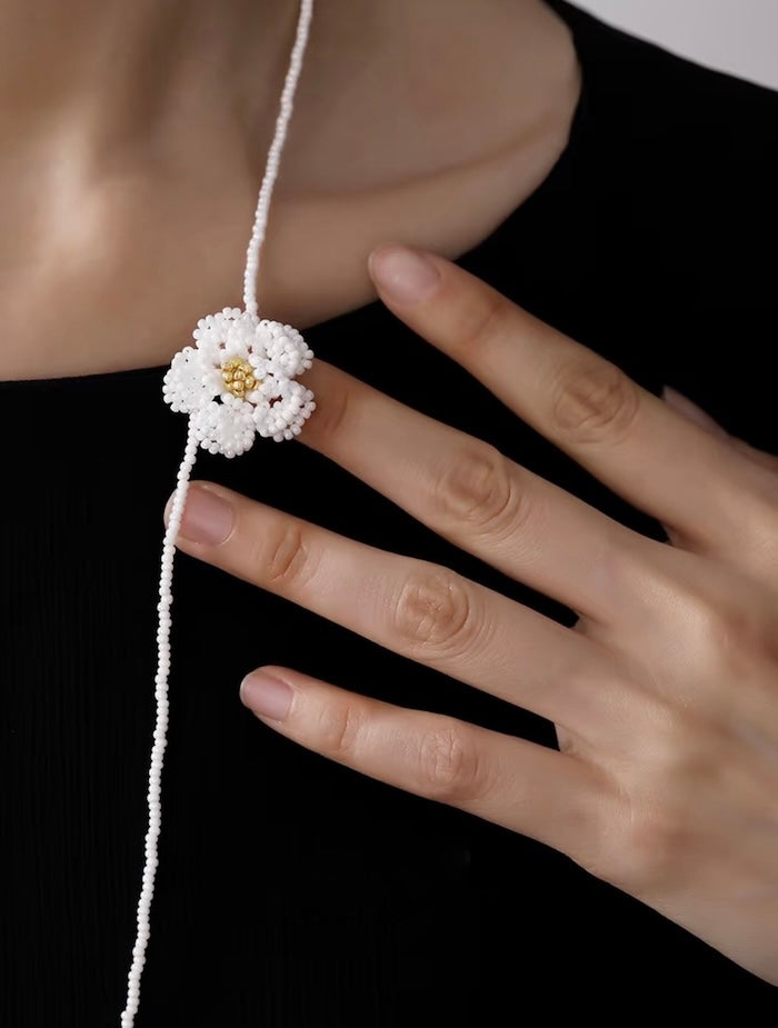 Handmade Daisy Beaded Necklace and Earrings Set featuring handwoven white daisy flowers with gold-tone accents, a 76 cm beaded necklace, and matching floral earrings.