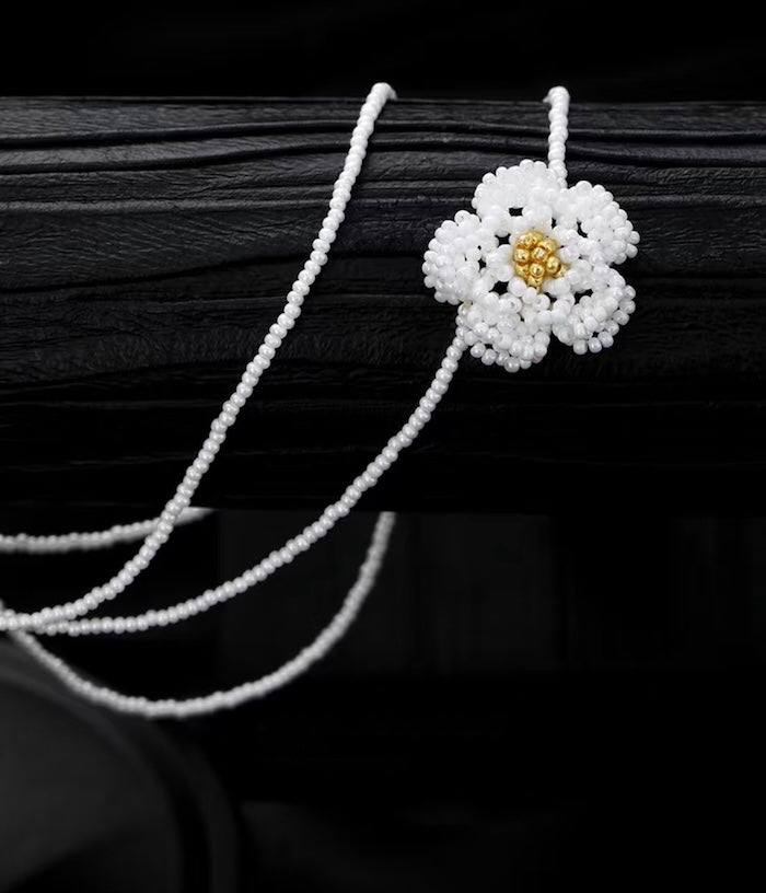 Handmade Daisy Beaded Necklace and Earrings Set featuring handwoven white daisy flowers with gold-tone accents, a 76 cm beaded necklace, and matching floral earrings.