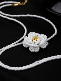 Handmade Daisy Beaded Necklace and Earrings Set featuring handwoven white daisy flowers with gold-tone accents, a 76 cm beaded necklace, and matching floral earrings.