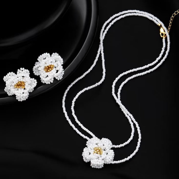 Handmade Daisy Beaded Necklace and Earrings Set featuring handwoven white daisy flowers with gold-tone accents, a 76 cm beaded necklace, and matching floral earrings.