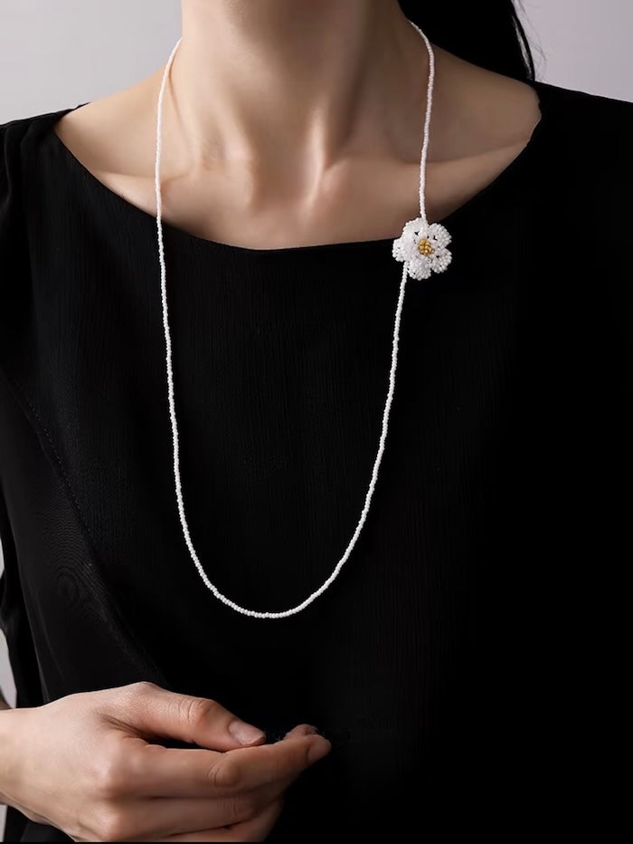 Handmade Daisy Beaded Necklace and Earrings Set featuring handwoven white daisy flowers with gold-tone accents, a 76 cm beaded necklace, and matching floral earrings.