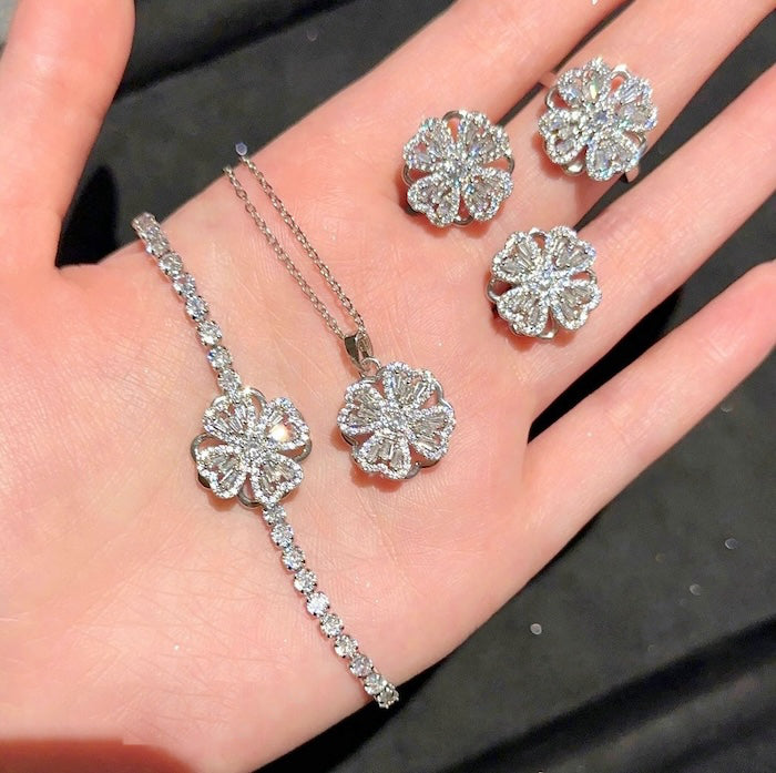 Dazzling Turning Four Leaf Clover Jewelry Set featuring rotating four-leaf clover earrings, pendant necklace, bracelet, and matching ring crafted in white gold plated brass with premium-grade zirconia.