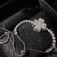 Dazzling Turning Four Leaf Clover Jewelry Set featuring rotating four-leaf clover earrings, pendant necklace, bracelet, and matching ring crafted in white gold plated brass with premium-grade zirconia.