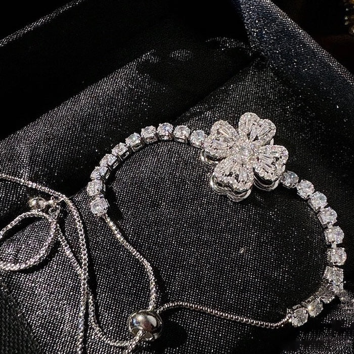 Dazzling Turning Four Leaf Clover Jewelry Set featuring rotating four-leaf clover earrings, pendant necklace, bracelet, and matching ring crafted in white gold plated brass with premium-grade zirconia.
