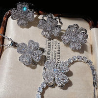 Dazzling Turning Four Leaf Clover Jewelry Set featuring rotating four-leaf clover earrings, pendant necklace, bracelet, and matching ring crafted in white gold plated brass with premium-grade zirconia.
