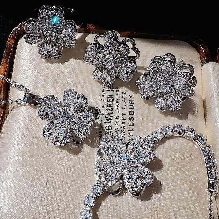 Dazzling Turning Four Leaf Clover Jewelry Set featuring rotating four-leaf clover earrings, pendant necklace, bracelet, and matching ring crafted in white gold plated brass with premium-grade zirconia.