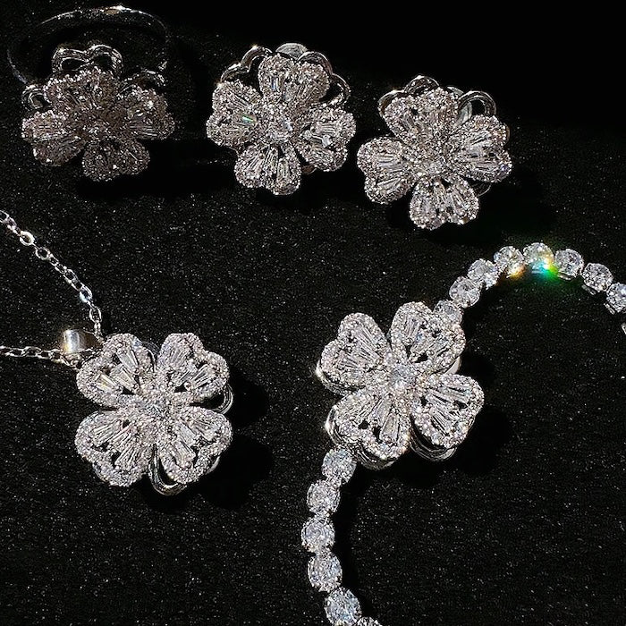 Dazzling Turning Four Leaf Clover Jewelry Set featuring rotating four-leaf clover earrings, pendant necklace, bracelet, and matching ring crafted in white gold plated brass with premium-grade zirconia.