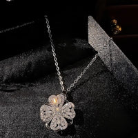 Dazzling Turning Four Leaf Clover Jewelry Set featuring rotating four-leaf clover earrings, pendant necklace, bracelet, and matching ring crafted in white gold plated brass with premium-grade zirconia.