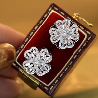 Dazzling Turning Four Leaf Clover Jewelry Set featuring rotating four-leaf clover earrings, pendant necklace, bracelet, and matching ring crafted in white gold plated brass with premium-grade zirconia.