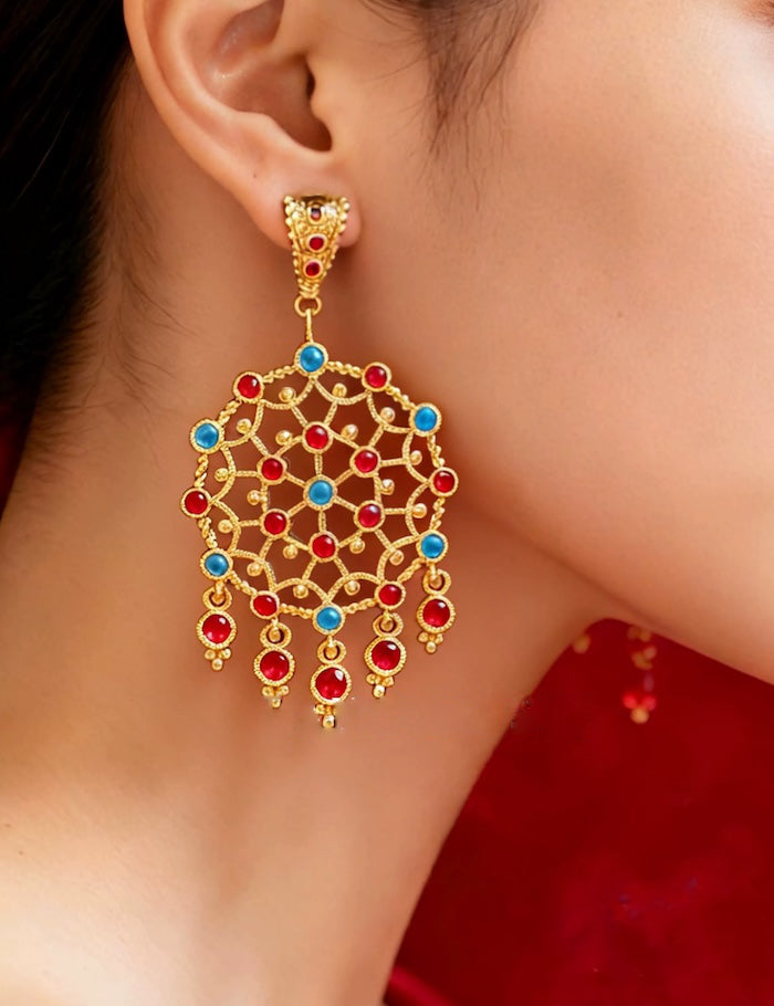 Vintage Dream Catcher Drop Earrings featuring intricate gold-tone openwork details with red and turquoise crystal accents in a statement drop design.

