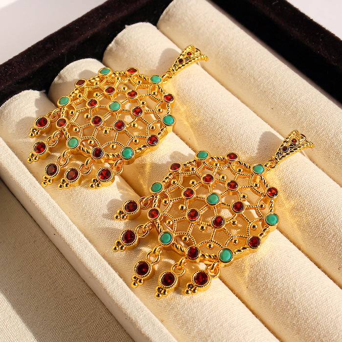 Vintage Dream Catcher Drop Earrings featuring intricate gold-tone openwork details with red and turquoise crystal accents in a statement drop design.
