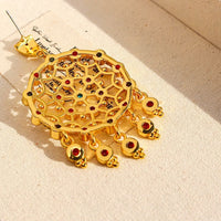 Vintage Dream Catcher Drop Earrings featuring intricate gold-tone openwork details with red and turquoise crystal accents in a statement drop design.
