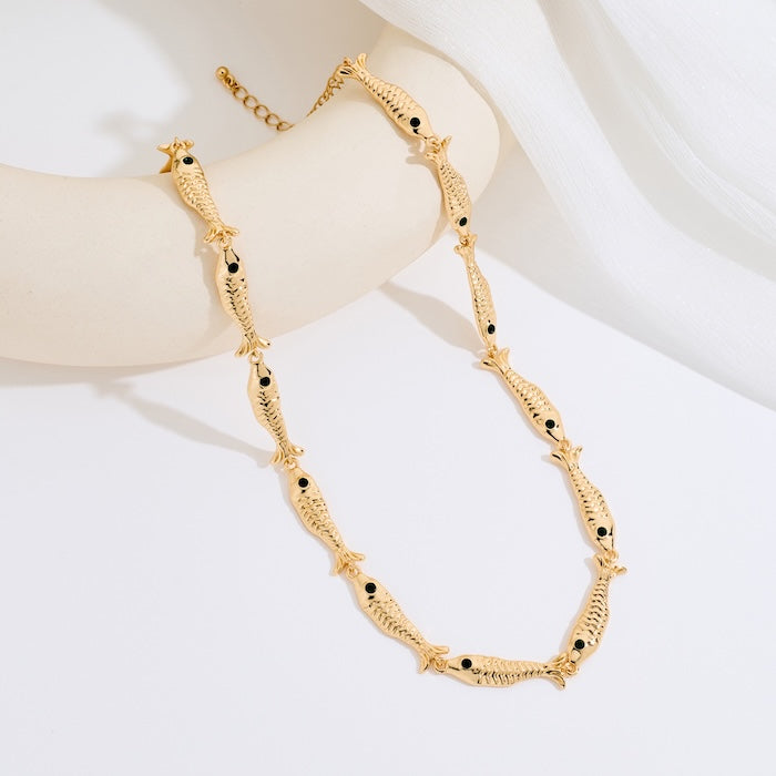 Vintage Fish Link Necklace featuring detailed gold-plated fish links connected in a playful vintage-inspired chain design.
