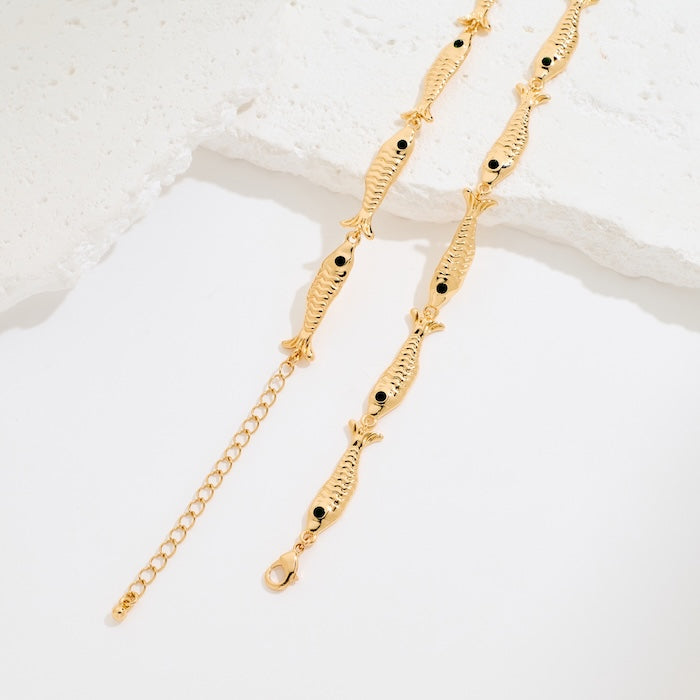 Vintage Fish Link Necklace featuring detailed gold-plated fish links connected in a playful vintage-inspired chain design.
