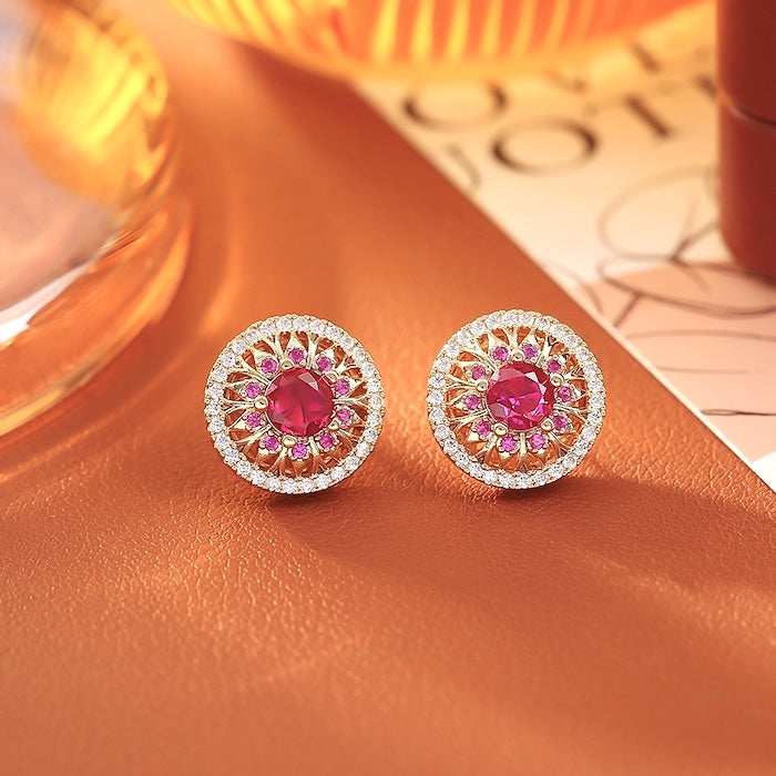 Vintage Style Halo Crystal Stud Earrings featuring a sparkling halo of zirconias surrounding a ruby red or sky blue center stone in a gold-tone vintage-inspired setting.
