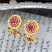 Vintage Style Halo Crystal Stud Earrings featuring a sparkling halo of zirconias surrounding a ruby red or sky blue center stone in a gold-tone vintage-inspired setting.
