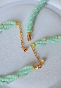Lucky Jade Braided Necklace and Bracelet Set featuring genuine jade beads in an intricate braided design with gold-tone accents, convertible into a longer necklace.