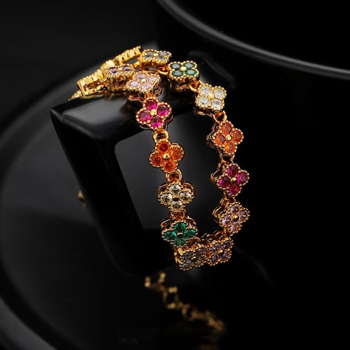 Kaleidoscope Clover Crystal Bracelet featuring gold-plated brass with multicoloured four-leaf clover motifs set with premium zirconia crystals and an adjustable chain.