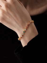 Kaleidoscope Clover Crystal Bracelet featuring gold-plated brass with multicoloured four-leaf clover motifs set with premium zirconia crystals and an adjustable chain.