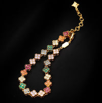 Kaleidoscope Clover Crystal Bracelet featuring gold-plated brass with multicoloured four-leaf clover motifs set with premium zirconia crystals and an adjustable chain.