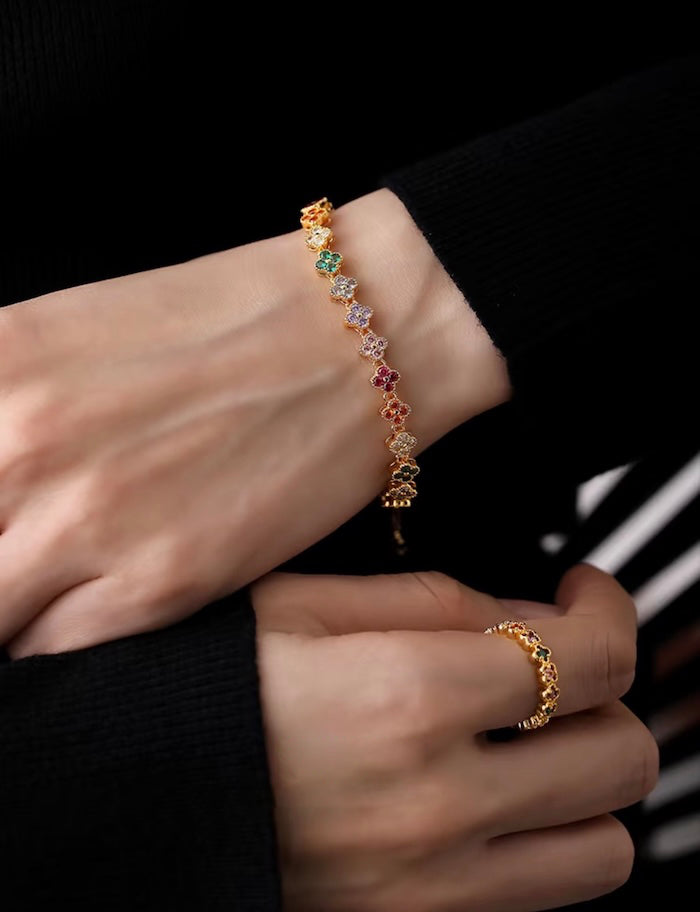 Kaleidoscope Clover Crystal Bracelet featuring gold-plated brass with multicoloured four-leaf clover motifs set with premium zirconia crystals and an adjustable chain.