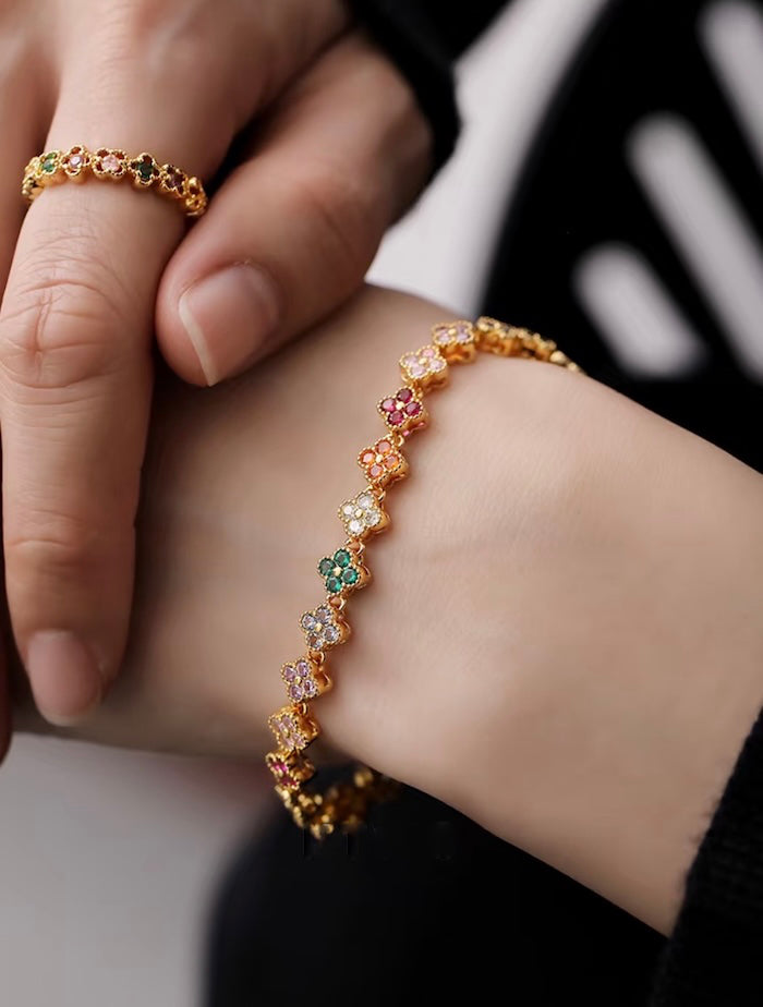 Kaleidoscope Clover Crystal Bracelet featuring gold-plated brass with multicoloured four-leaf clover motifs set with premium zirconia crystals and an adjustable chain.