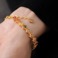 Kaleidoscope Clover Crystal Bracelet featuring gold-plated brass with multicoloured four-leaf clover motifs set with premium zirconia crystals and an adjustable chain.