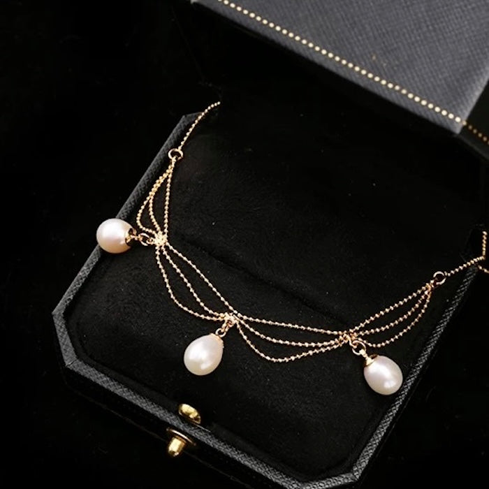 Lace Style Necklace with Genuine Freshwater PearlsLace Style Necklace with Genuine Freshwater Pearls featuring delicate layered chains and genuine baroque pearl drops in gold and silver-tone finishes, available in 3-pearl and 7-pearl designs.
