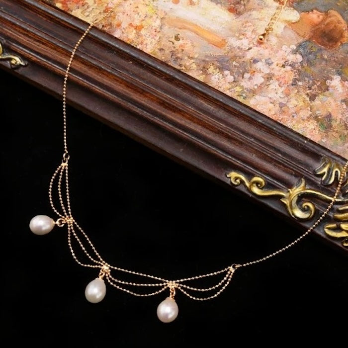 Lace Style Necklace with Genuine Freshwater Pearls featuring delicate layered chains and genuine baroque pearl drops in gold and silver-tone finishes, available in 3-pearl and 7-pearl designs.
