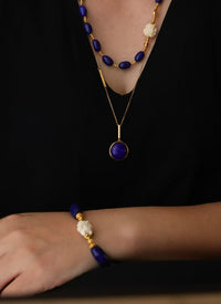 Imperial Lapis Lazuli Guardian Bracelet featuring genuine curved lapis lazuli beads, a hand-carved guardian bead, and gold vermeil accents in a handcrafted vintage-inspired design.
