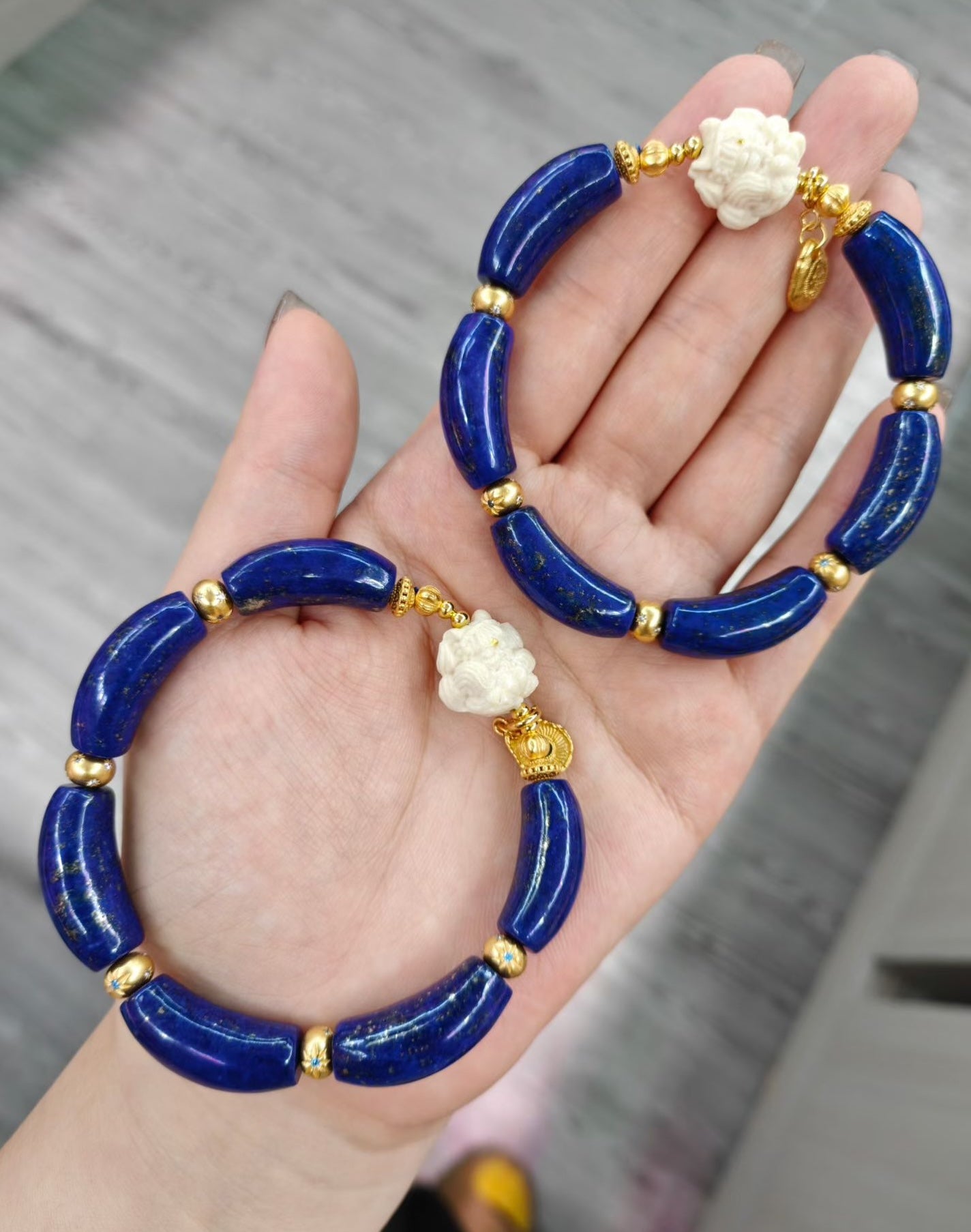 Imperial Lapis Lazuli Guardian Bracelet featuring genuine curved lapis lazuli beads, a hand-carved guardian bead, and gold vermeil accents in a handcrafted vintage-inspired design.
