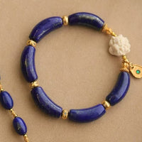 Imperial Lapis Lazuli Guardian Bracelet featuring genuine curved lapis lazuli beads, a hand-carved guardian bead, and gold vermeil accents in a handcrafted vintage-inspired design.
