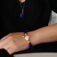Imperial Lapis Lazuli Guardian Bracelet featuring genuine curved lapis lazuli beads, a hand-carved guardian bead, and gold vermeil accents in a handcrafted vintage-inspired design.
