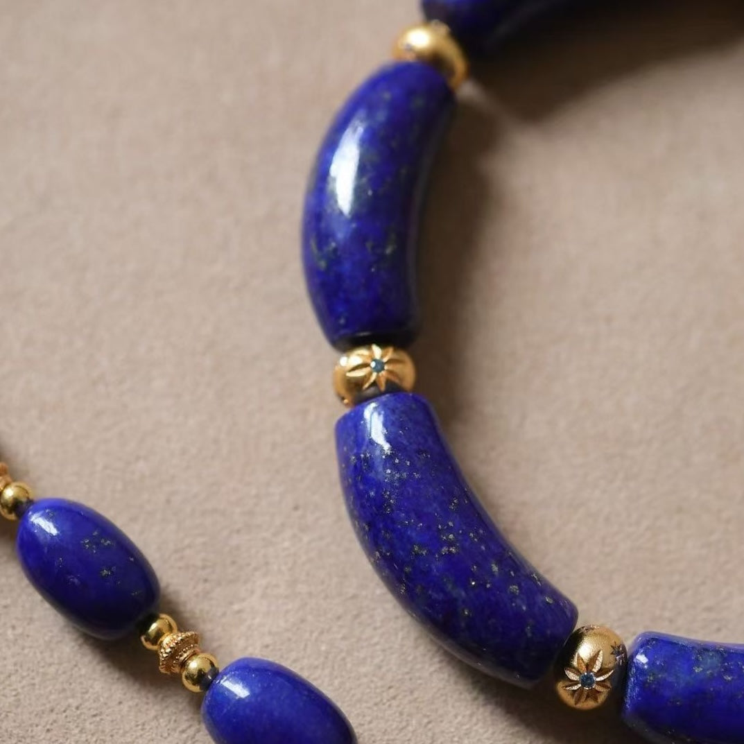 Imperial Lapis Lazuli Guardian Bracelet featuring genuine curved lapis lazuli beads, a hand-carved guardian bead, and gold vermeil accents in a handcrafted vintage-inspired design.
