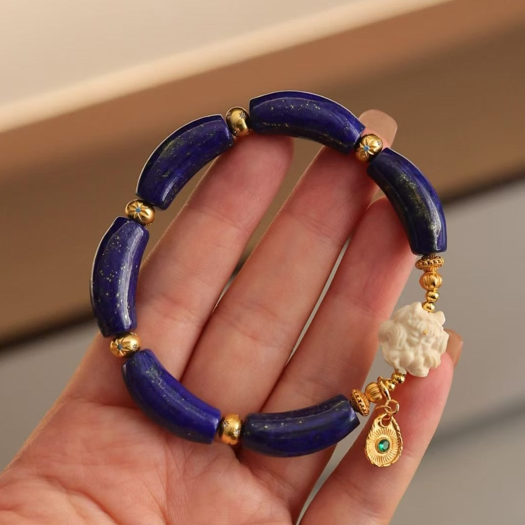Imperial Lapis Lazuli Guardian Bracelet featuring genuine curved lapis lazuli beads, a hand-carved guardian bead, and gold vermeil accents in a handcrafted vintage-inspired design.
