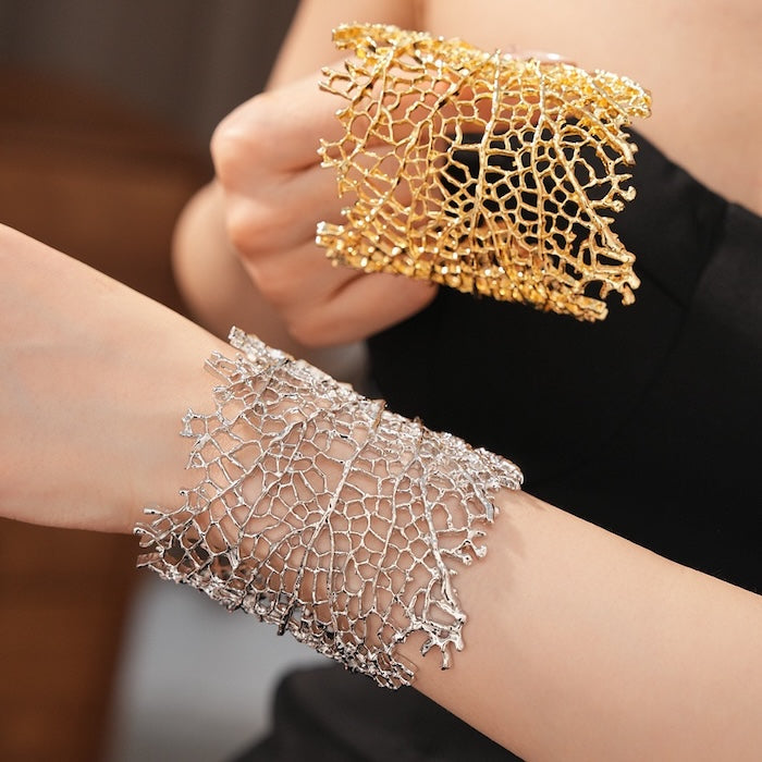 Gilded Leaf Vein Cuff Bracelet with an intricate leaf vein-inspired openwork design in gold-plated or silver-tone alloy featuring a wide sculptural silhouette.