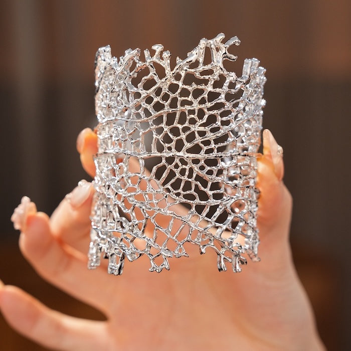 Gilded Leaf Vein Cuff Bracelet with an intricate leaf vein-inspired openwork design in gold-plated or silver-tone alloy featuring a wide sculptural silhouette.