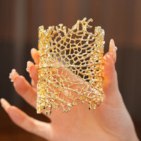 Gilded Leaf Vein Cuff Bracelet with an intricate leaf vein-inspired openwork design in gold-plated or silver-tone alloy featuring a wide sculptural silhouette.