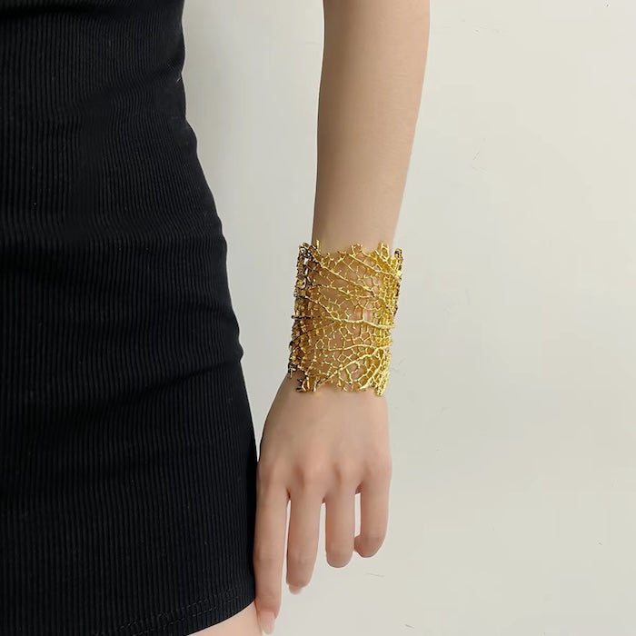 Gilded Leaf Vein Cuff Bracelet with an intricate leaf vein-inspired openwork design in gold-plated or silver-tone alloy featuring a wide sculptural silhouette.