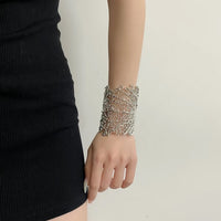 Gilded Leaf Vein Cuff Bracelet with an intricate leaf vein-inspired openwork design in gold-plated or silver-tone alloy featuring a wide sculptural silhouette.