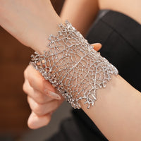 Gilded Leaf Vein Cuff Bracelet with an intricate leaf vein-inspired openwork design in gold-plated or silver-tone alloy featuring a wide sculptural silhouette.
