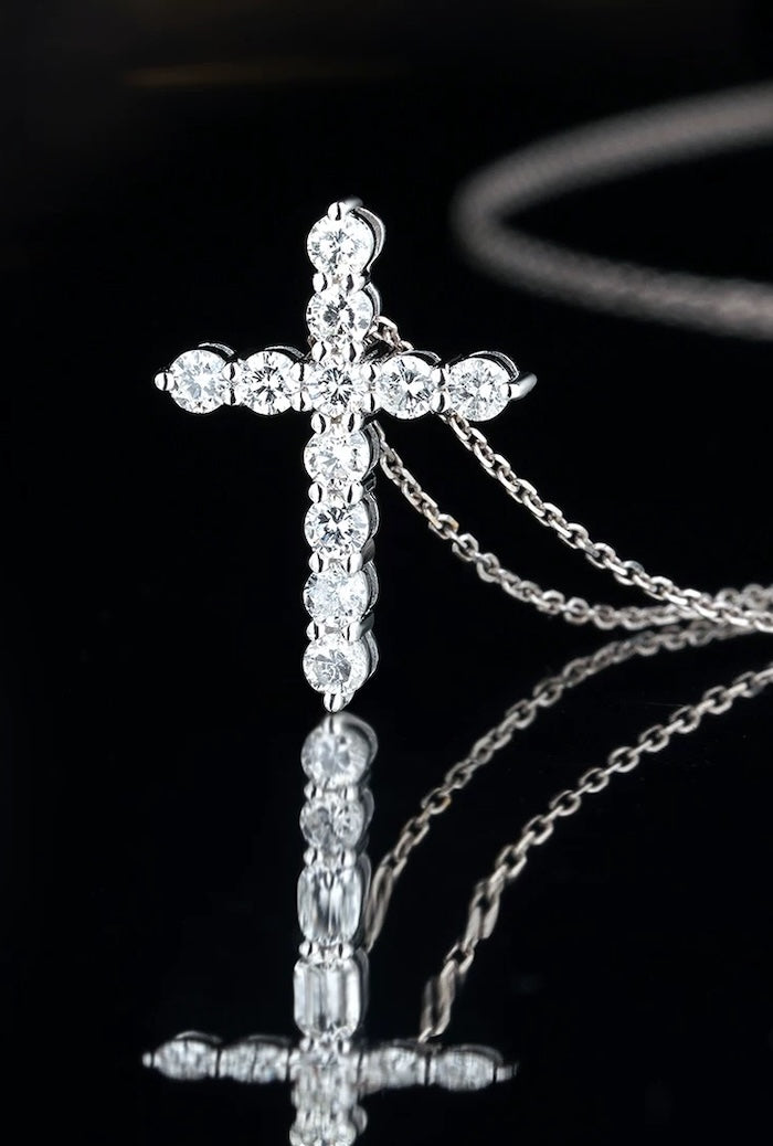 Moissanite Cross Pendant Necklace featuring a sterling silver cross pendant set with eleven sparkling moissanite stones, measuring 2.8 × 0.3 cm.